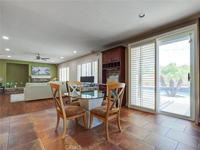 8242 Daisy Ln, Riverside, CA 92508 - dining area featuring a ceiling fan, a fireplace, and recessed lighting