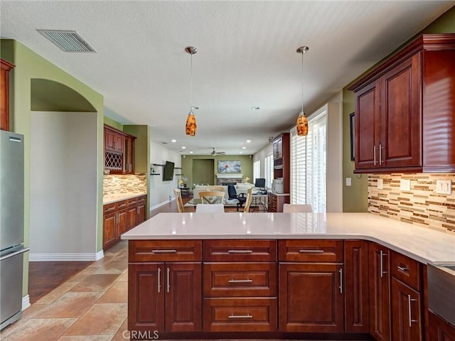 8242 Daisy Ln, Riverside, CA 92508 - kitchen with freestanding refrigerator, a peninsula, decorative backsplash, light countertops, and recessed lighting