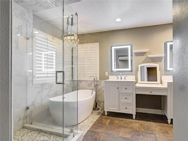 8242 Daisy Ln, Riverside, CA 92508 - full bathroom featuring vanity, a soaking tub, a shower stall, a chandelier, and recessed lighting