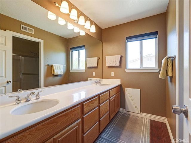 8242 Daisy Ln, Riverside, CA 92508 - bathroom with double vanity, baseboards, and an enclosed shower