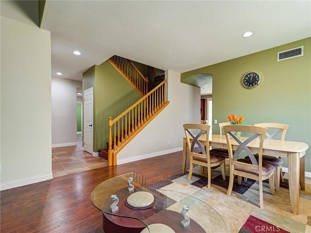 8242 Daisy Ln, Riverside, CA 92508 - dining area with wood finished floors, stairs, recessed lighting, arched walkways, and baseboards