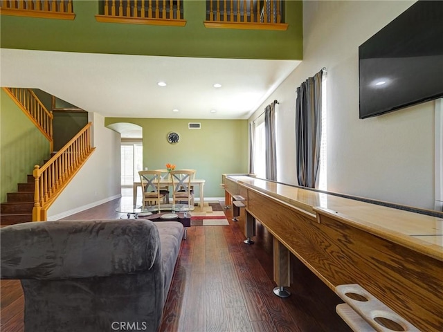 8242 Daisy Ln, Riverside, CA 92508 - living room with arched walkways, dark wood finished floors, plenty of natural light, stairs, and recessed lighting