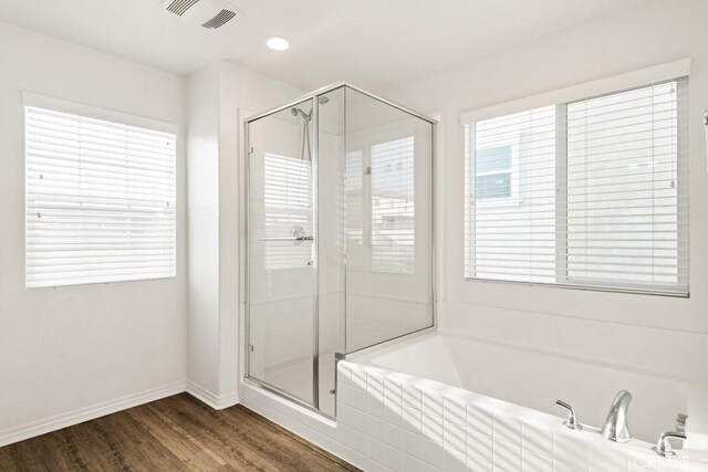 14226 Sonoma Ct, Beaumont, CA 92223 - bathroom with a bath, a shower stall, wood finished floors, baseboards, and recessed lighting