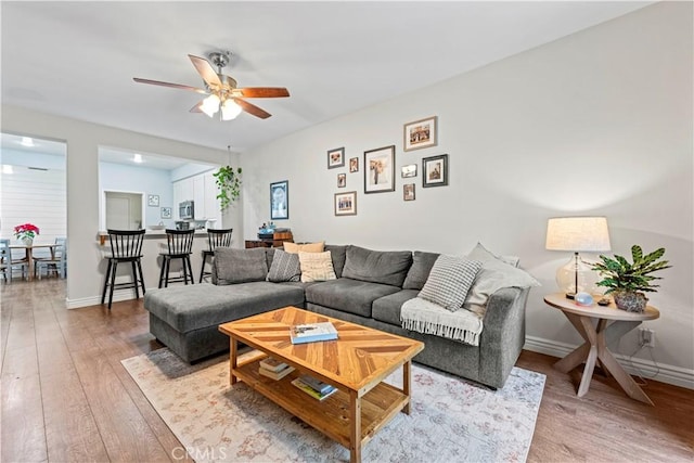 23411 Abbey Glen Pl Unit 41, Valencia, CA 91354 - living area with light wood finished floors, ceiling fan, and baseboards
