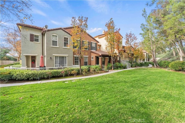 23411 Abbey Glen Pl Unit 41, Valencia, CA 91354 - view of front facade featuring a front yard, stucco siding, and a tiled roof