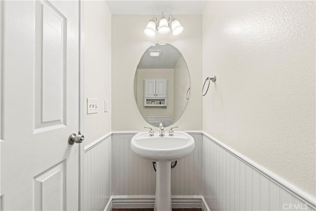 23411 Abbey Glen Pl Unit 41, Valencia, CA 91354 - bathroom with wainscoting, a chandelier, and a decorative wall