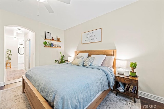 23411 Abbey Glen Pl Unit 41, Valencia, CA 91354 - bedroom with arched walkways, wood finished floors, baseboards, ensuite bathroom, and a ceiling fan