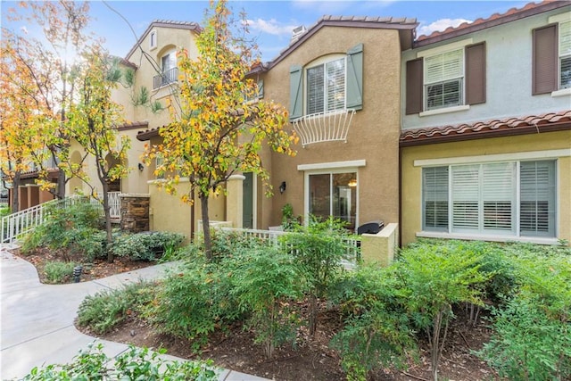 23411 Abbey Glen Pl Unit 41, Valencia, CA 91354 - mediterranean / spanish-style house featuring a tiled roof and stucco siding