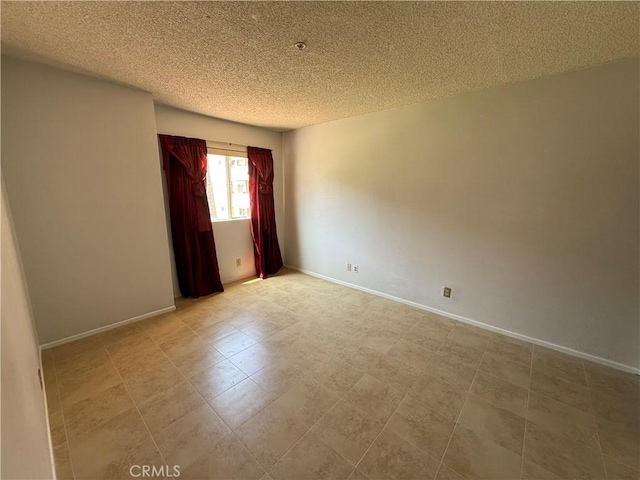 450 E 4th St Unit 207, Santa Ana, CA 92701 - empty room with a textured ceiling and baseboards