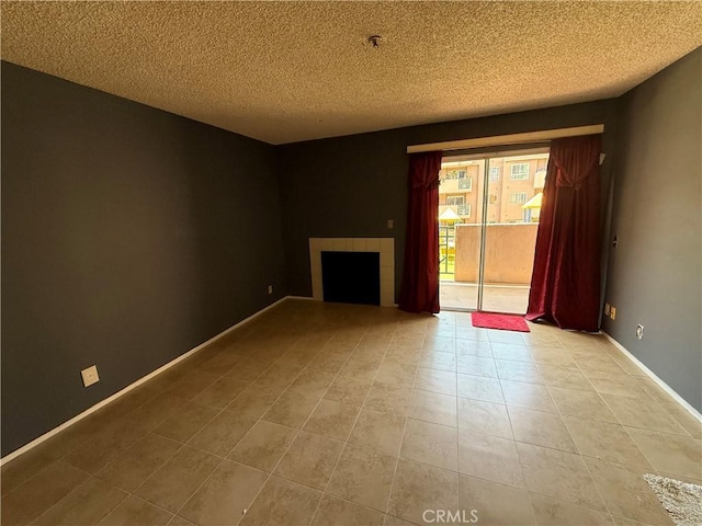 450 E 4th St Unit 207, Santa Ana, CA 92701 - unfurnished living room with a tile fireplace, a textured ceiling, tile patterned floors, and baseboards
