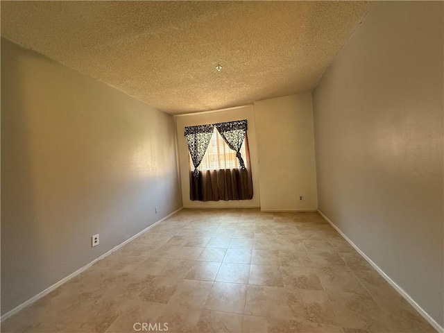 450 E 4th St Unit 207, Santa Ana, CA 92701 - unfurnished room featuring a textured ceiling and baseboards