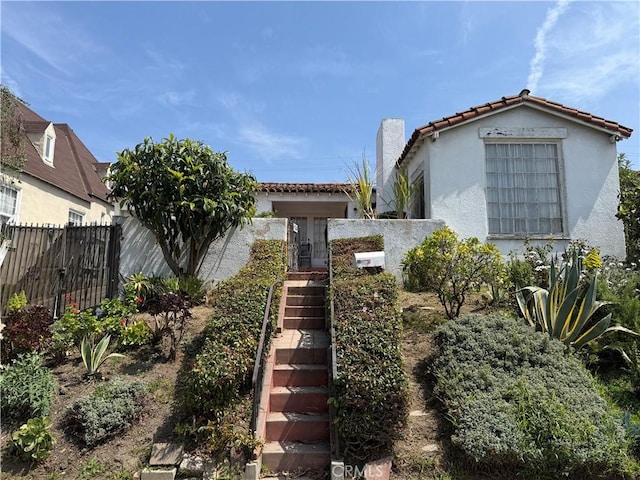 920 S Spaulding Ave S, Los Angeles, CA 90036 - view of front of house featuring a tile roof, stairway, and stucco siding