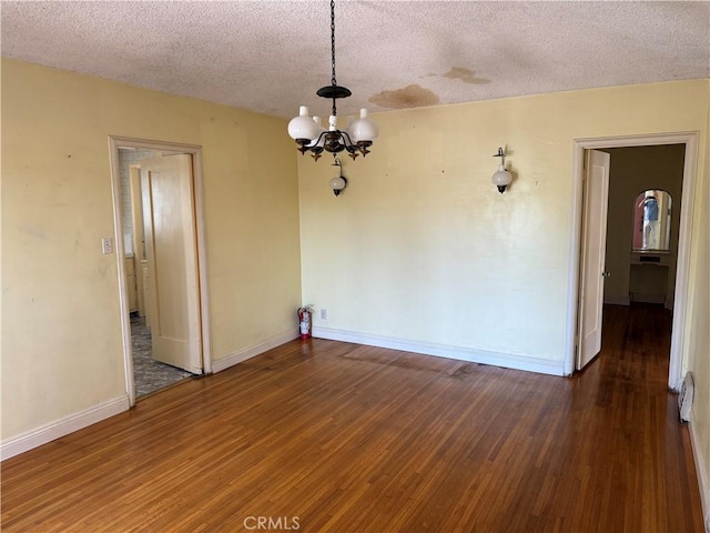 920 S Spaulding Ave S, Los Angeles, CA 90036 - empty room with a textured ceiling, a chandelier, wood finished floors, and baseboards