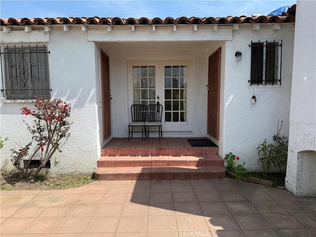 920 S Spaulding Ave S, Los Angeles, CA 90036 - entrance to property with french doors, stucco siding, and a tiled roof