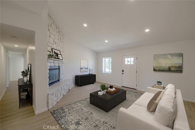 16754 Pauhaska Rd, Apple Valley, CA 92307 - living area featuring light wood finished floors, a stone fireplace, recessed lighting, and baseboards