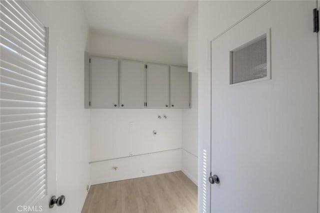 16754 Pauhaska Rd, Apple Valley, CA 92307 - laundry room featuring cabinet space, light wood finished floors, and baseboards