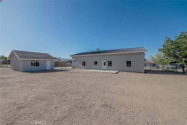 16754 Pauhaska Rd, Apple Valley, CA 92307 - rear view of house featuring a patio area, stucco siding, and a chimney