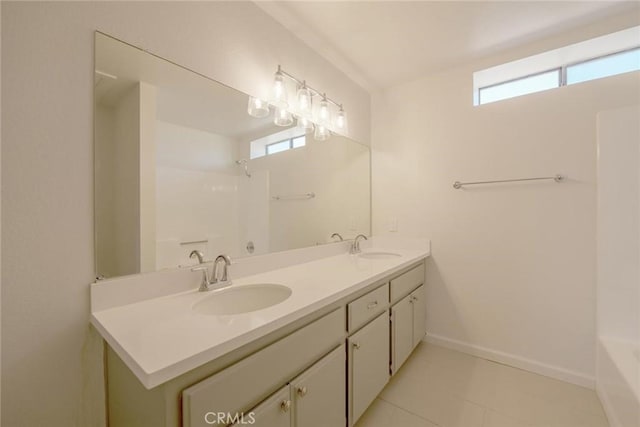 16754 Pauhaska Rd, Apple Valley, CA 92307 - full bath featuring double vanity, tile patterned flooring, baseboards, and shower / bath combination