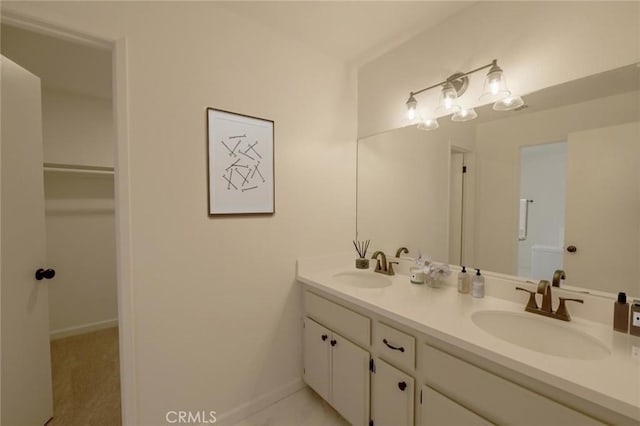 16754 Pauhaska Rd, Apple Valley, CA 92307 - bathroom with double vanity, a walk in closet, and baseboards
