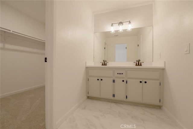 16754 Pauhaska Rd, Apple Valley, CA 92307 - full bathroom with double vanity, baseboards, and a walk in closet