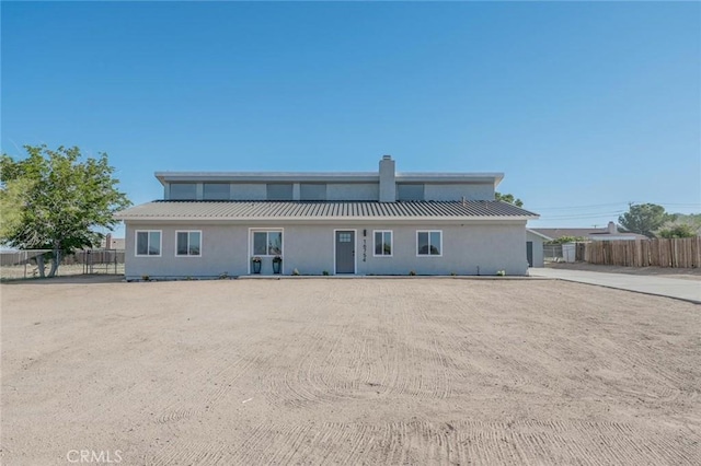 16754 Pauhaska Rd, Apple Valley, CA 92307 - view of front facade with a chimney, metal roof, and stucco siding