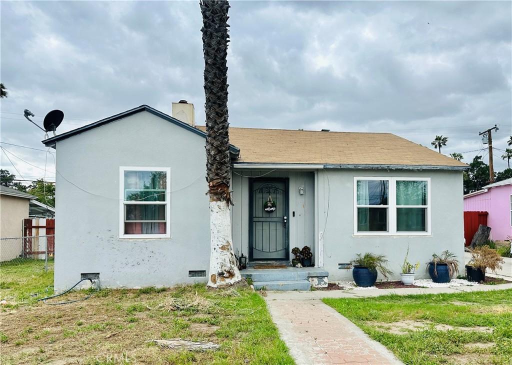 8580 Mango Ave, Fontana, CA 92335 - bungalow-style home featuring stucco siding and a chimney