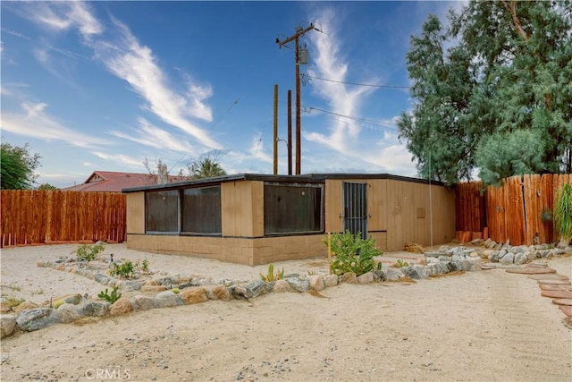 16811 Via Quedo, Desert Hot Springs, CA 92240 - back of house with a fenced backyard and a sunroom