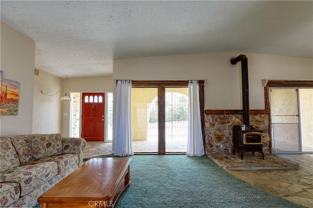 16811 Via Quedo, Desert Hot Springs, CA 92240 - carpeted living room with a wood stove and a textured ceiling