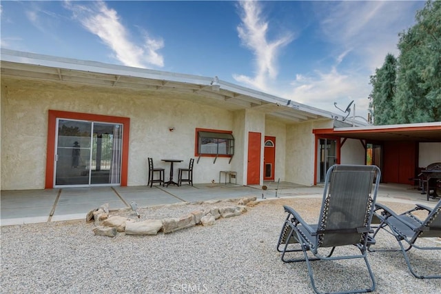 16811 Via Quedo, Desert Hot Springs, CA 92240 - back of property with stucco siding and a patio area