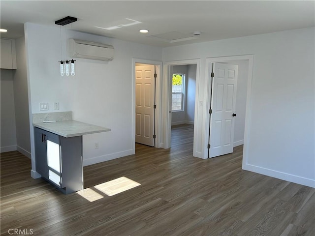 2033 W Burnett St, Long Beach, CA 90810 - kitchen featuring a wall mounted air conditioner, baseboards, wood finished floors, light countertops, and recessed lighting