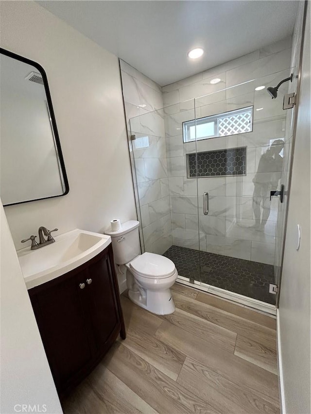 2033 W Burnett St, Long Beach, CA 90810 - full bath featuring toilet, vanity, a shower stall, wood finished floors, and recessed lighting