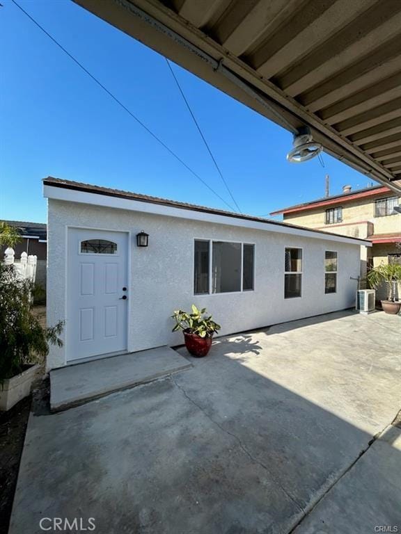 2033 W Burnett St, Long Beach, CA 90810 - back of house with stucco siding, a patio area, and central air condition unit
