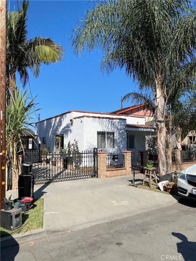 2033 W Burnett St, Long Beach, CA 90810 - view of front of property with stucco siding, a fenced front yard, and a gate