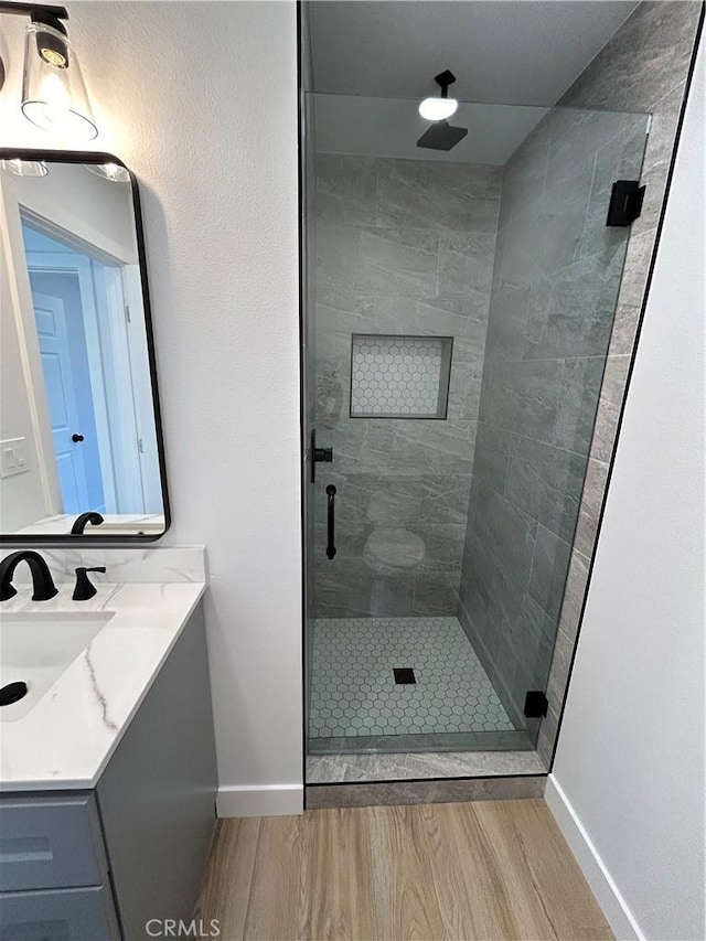 2033 W Burnett St, Long Beach, CA 90810 - full bath with baseboards, wood finished floors, a shower stall, and vanity