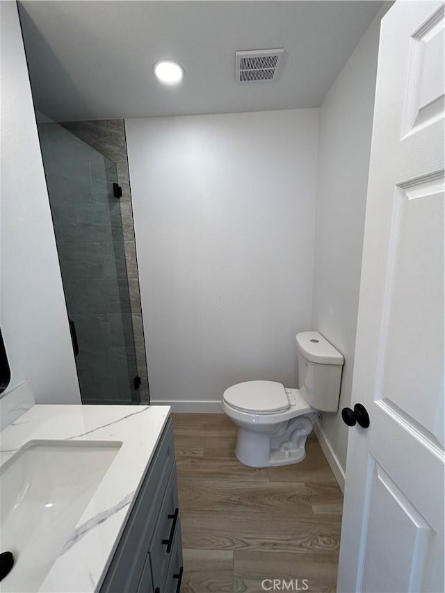 2033 W Burnett St, Long Beach, CA 90810 - full bathroom featuring toilet, wood finished floors, a shower stall, vanity, and recessed lighting