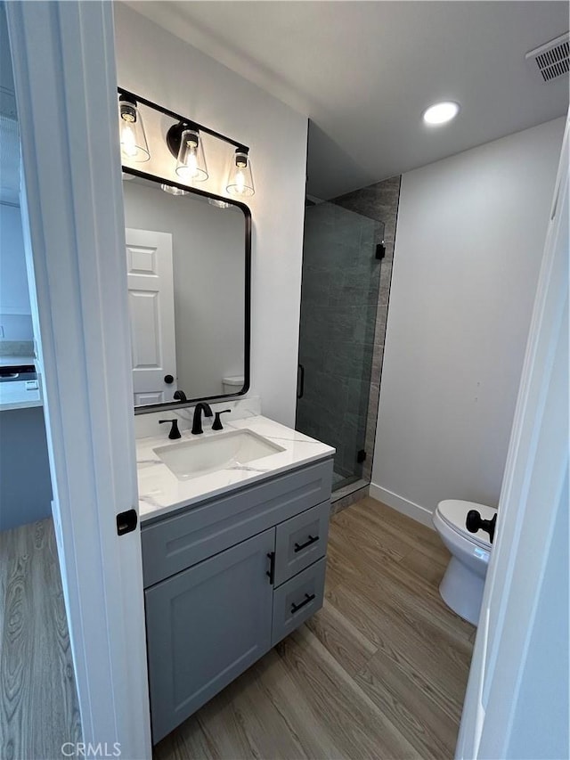 2033 W Burnett St, Long Beach, CA 90810 - bathroom featuring toilet, vanity, a shower stall, recessed lighting, and wood finished floors
