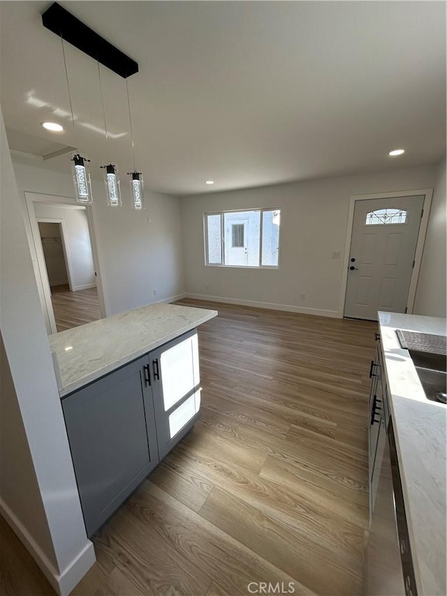2033 W Burnett St, Long Beach, CA 90810 - kitchen featuring light wood-style floors, a sink, baseboards, light stone countertops, and recessed lighting
