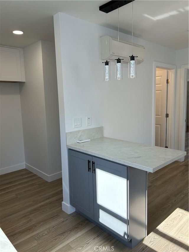 2033 W Burnett St, Long Beach, CA 90810 - kitchen with wood finished floors, baseboards, a peninsula, recessed lighting, and hanging light fixtures