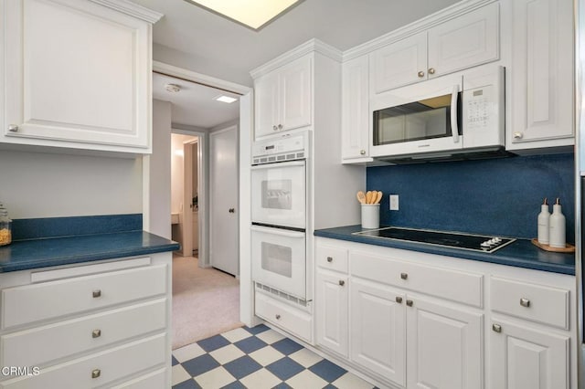1045 S Orange Grove Blvd Unit 8, Pasadena, CA 91105 - kitchen featuring white appliances, dark countertops, white cabinets, and light flooring