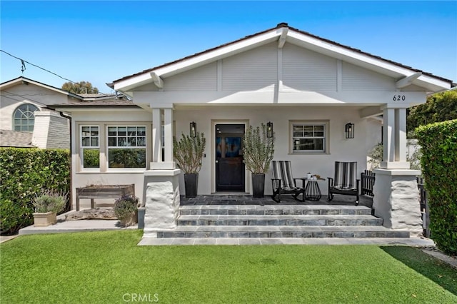 620 Brooks St, Laguna Beach, CA 92651 - back of property featuring a porch, a lawn, and stucco siding
