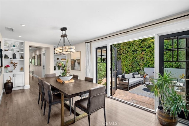 620 Brooks St, Laguna Beach, CA 92651 - dining space with wood finished floors, a chandelier, built in features, and recessed lighting