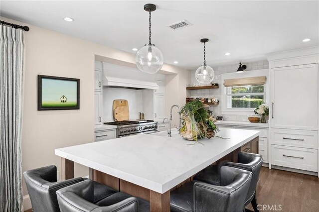 620 Brooks St, Laguna Beach, CA 92651 - kitchen with range, custom range hood, a kitchen breakfast bar, white cabinets, and recessed lighting