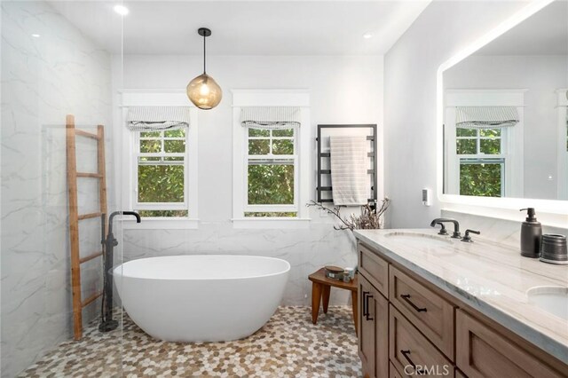 620 Brooks St, Laguna Beach, CA 92651 - bathroom featuring tile walls, a freestanding tub, double vanity, and wainscoting