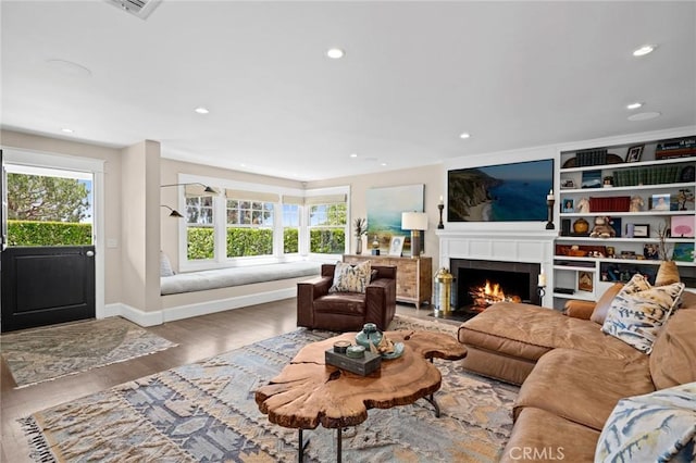620 Brooks St, Laguna Beach, CA 92651 - living area with healthy amount of natural light, wood finished floors, a warm lit fireplace, recessed lighting, and baseboards