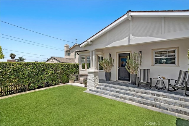 620 Brooks St, Laguna Beach, CA 92651 - view of exterior entry with a lawn, stucco siding, and covered porch