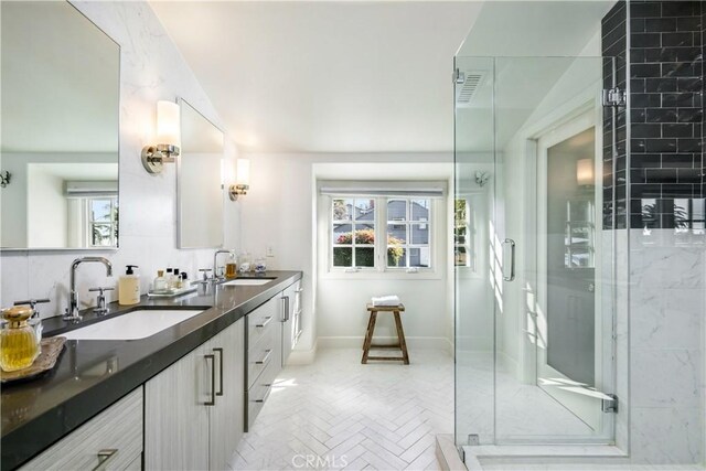 31847 8th Ave, Laguna Beach, CA 92651 - bathroom with double vanity, a shower stall, baseboards, and vaulted ceiling