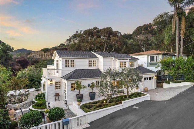 31847 8th Ave, Laguna Beach, CA 92651 - view of front of home with a balcony, driveway, an attached garage, and a mountain view