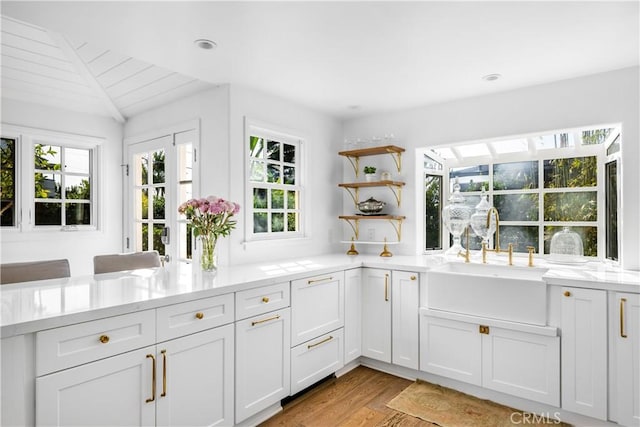 31847 8th Ave, Laguna Beach, CA 92651 - kitchen featuring a sink, open shelves, light wood finished floors, white cabinetry, and vaulted ceiling