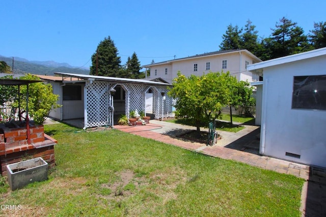 5021 Alvarado St, Carpinteria, CA 93013 - back of house featuring a lawn, a patio, and a mountain view