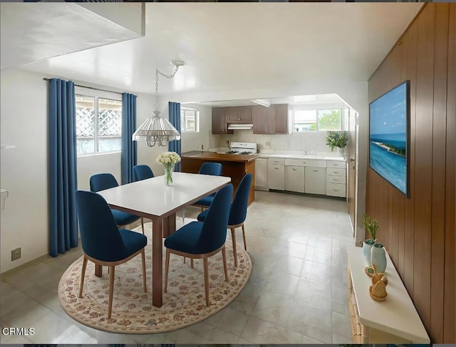 5021 Alvarado St, Carpinteria, CA 93013 - dining room with plenty of natural light, light floors, and wood walls